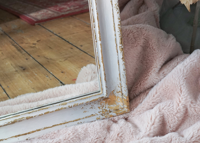 Close up of the pink, lavender and white ombre full length mirror with gold leaf details