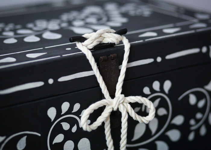 A close up of the rope fastening on the antique black and white wooden box, hand painted using Annie Sloan paint.
