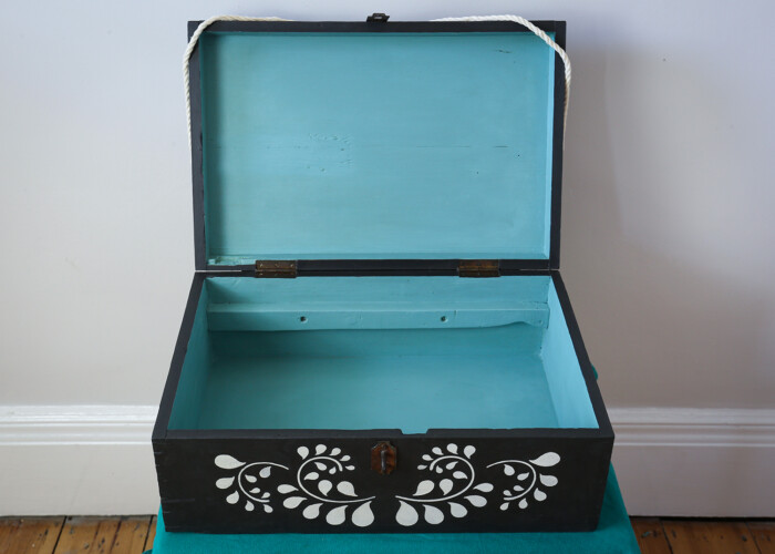 Antique wooden box, inside has been paint blue using Annie Sloan paint. The outside is black with white stenciled designs.