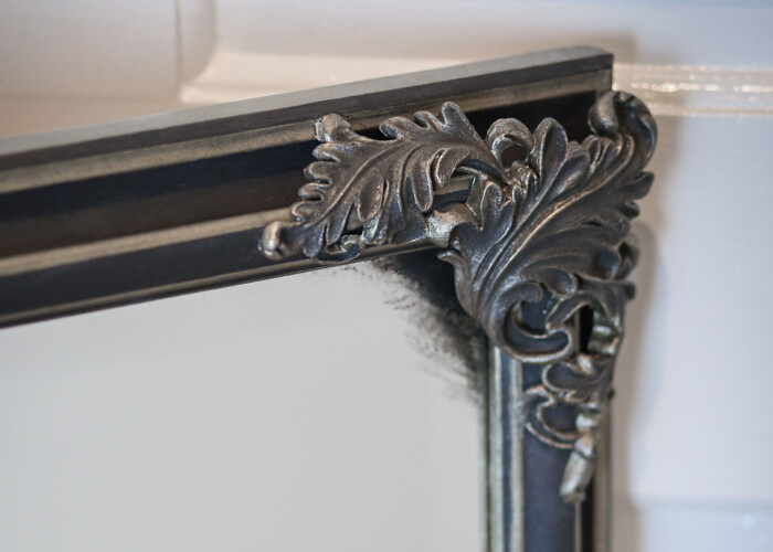 Close up of a renaissance style large black and gold mirror