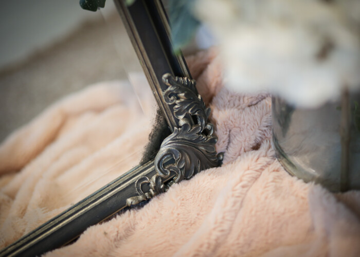 Close up of a renaissance style large black and gold mirror