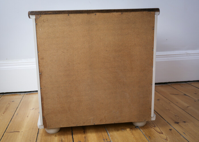 Back of a taupe bedside table